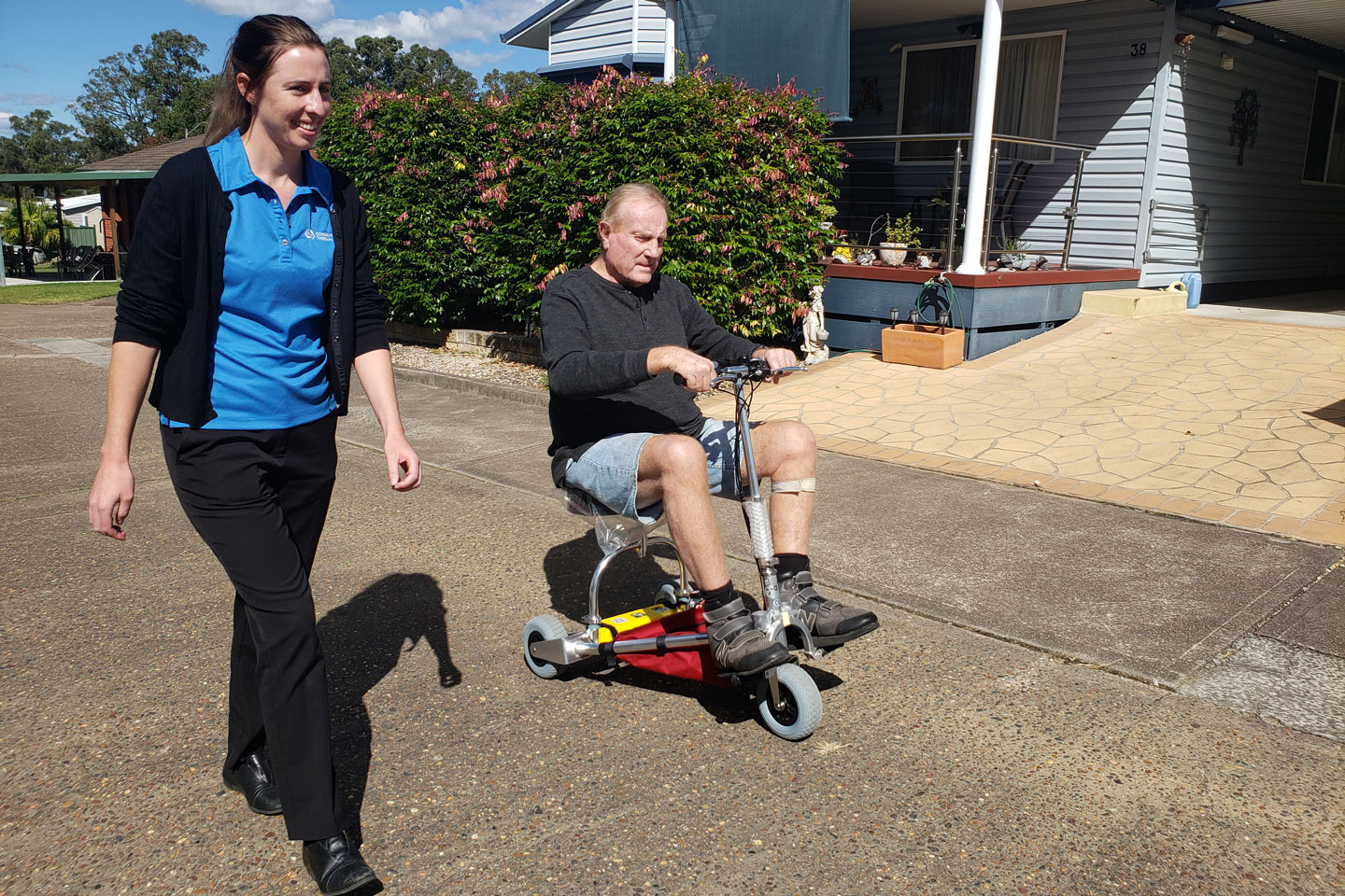 Occupational Therapist and client trialling a portable scooter