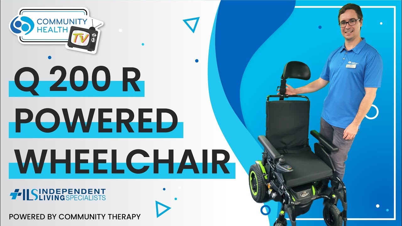 Scott standing next to a Q 200 R powered wheelchair