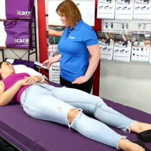 Clinician adjusting an electric profiling bed height