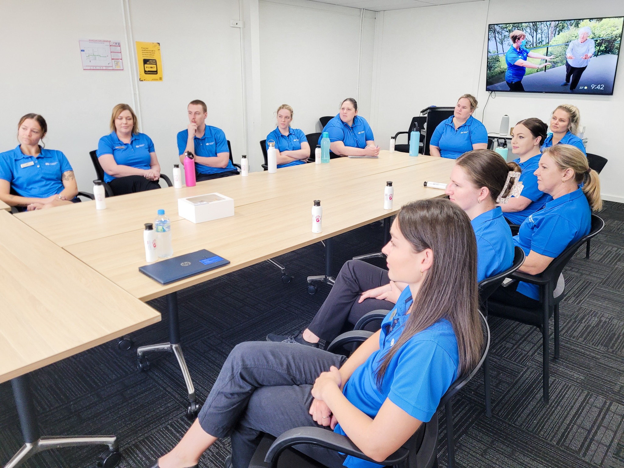 Many Community Therapy employees sitting around a table in a meeting