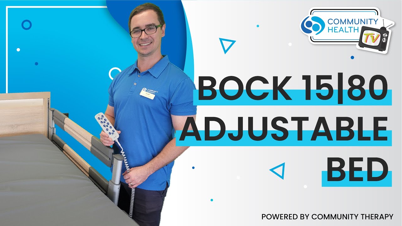 Scott holding the remote and standing next to a bock adjustable bed