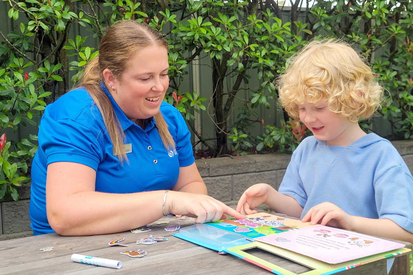 Speech Pathologist supporting a young boy with receptive and expressive language support