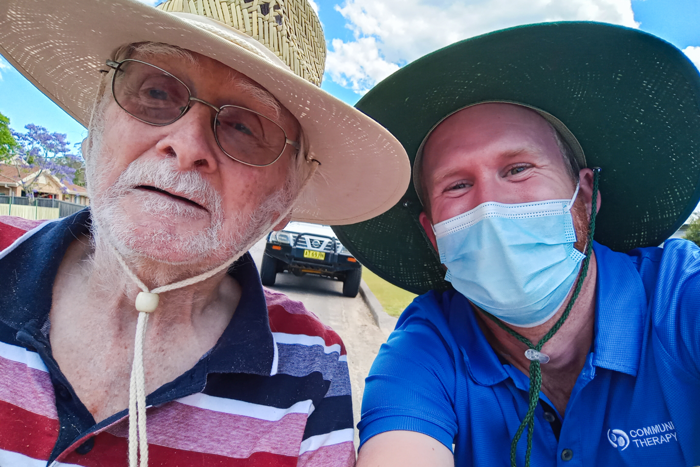Selfie of aged care client and clinician wearing brim hats