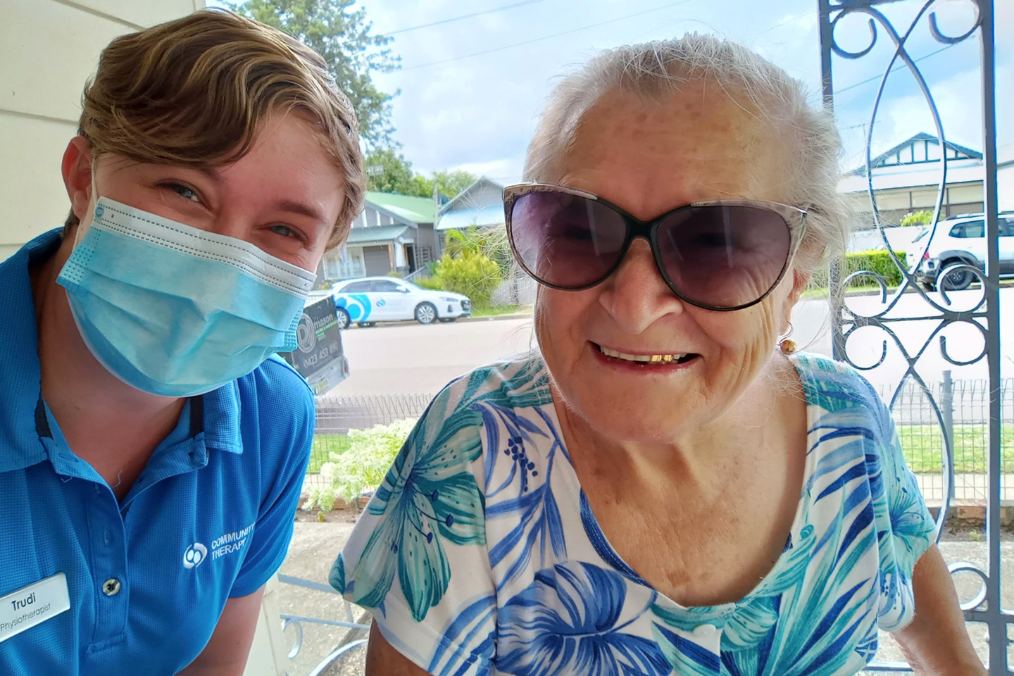 Physiotherapist and older adult smiling while taking a selfie