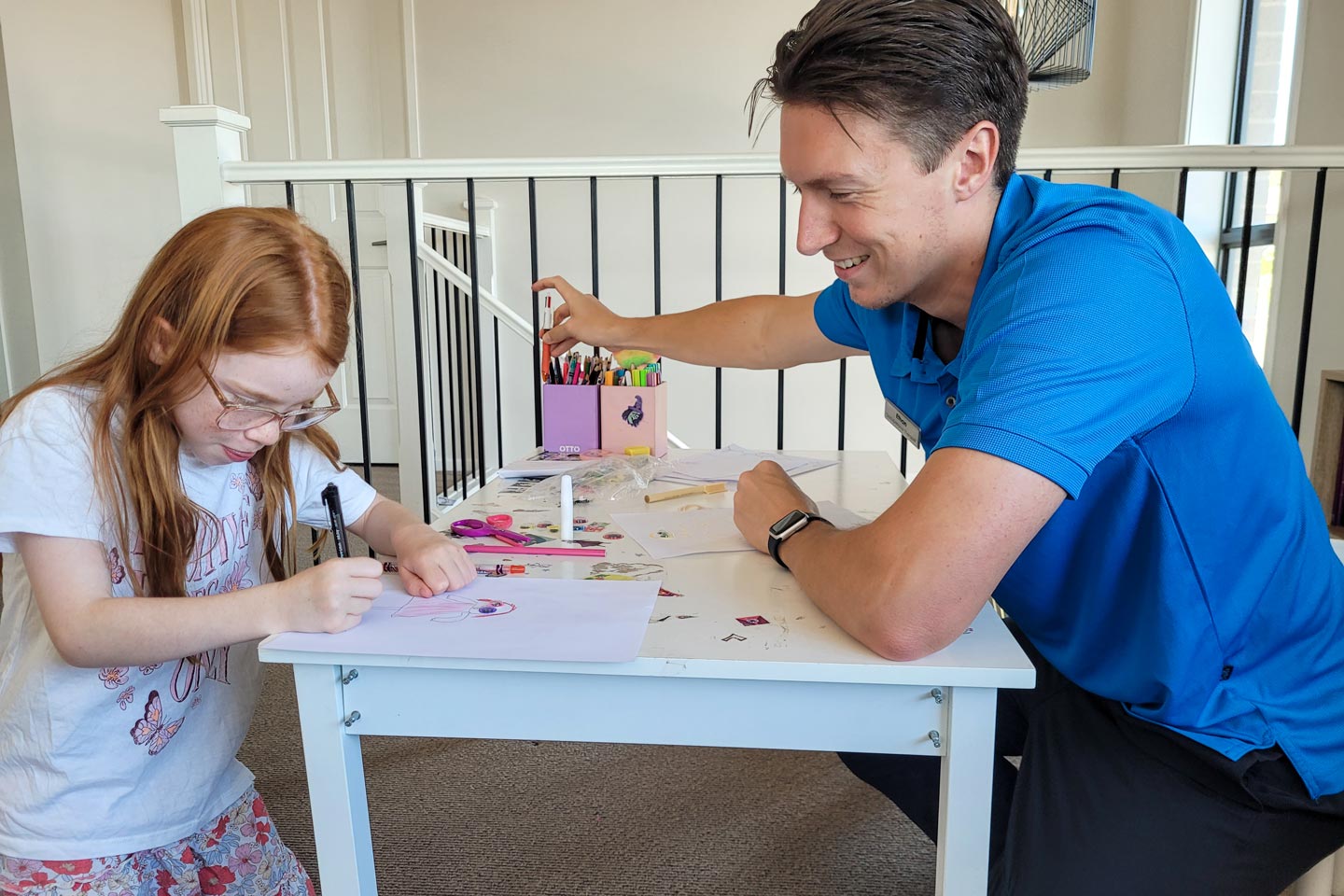 Occupational Therapist and 7 year old girl drawing