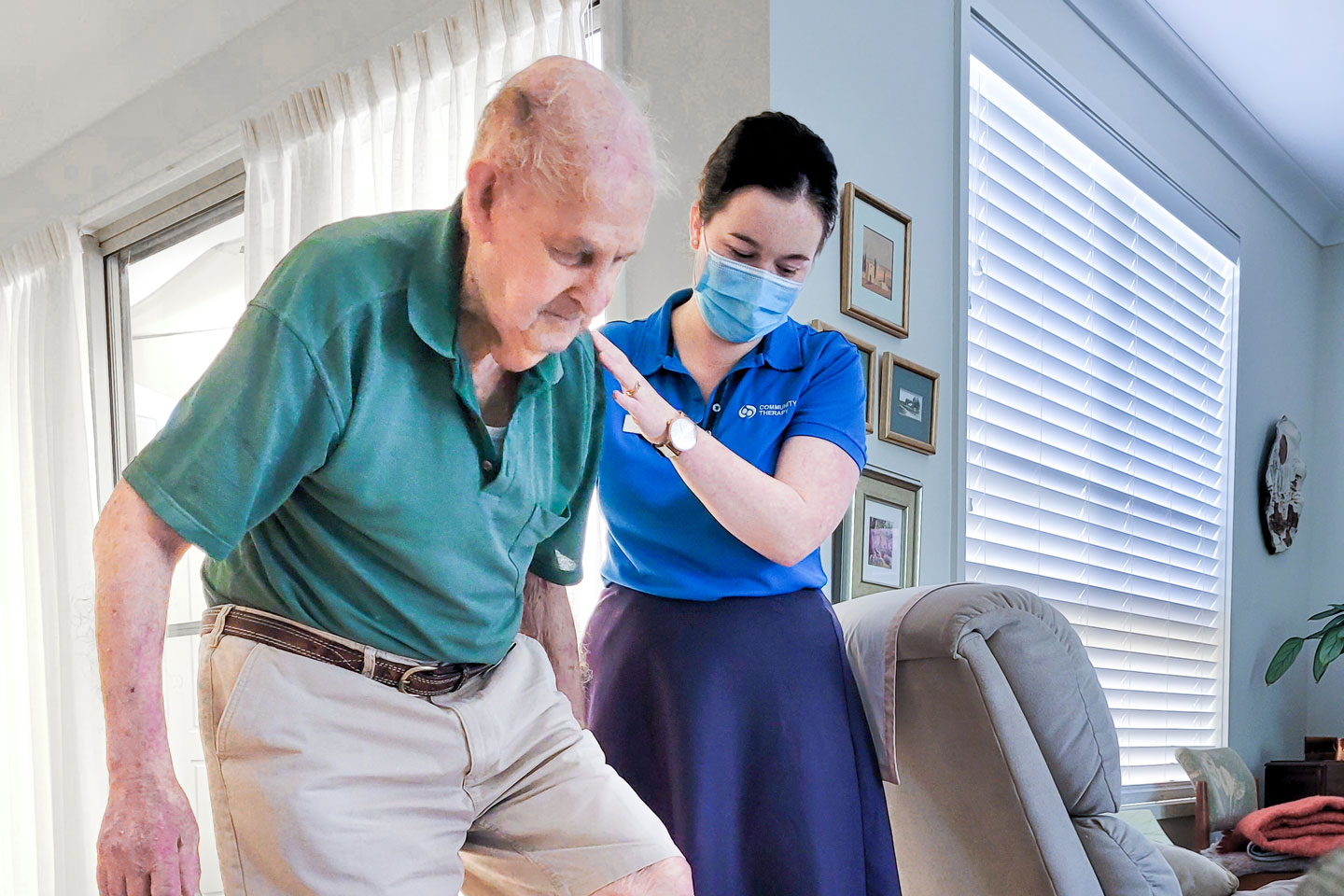Physiotherapist assisting client with exercises