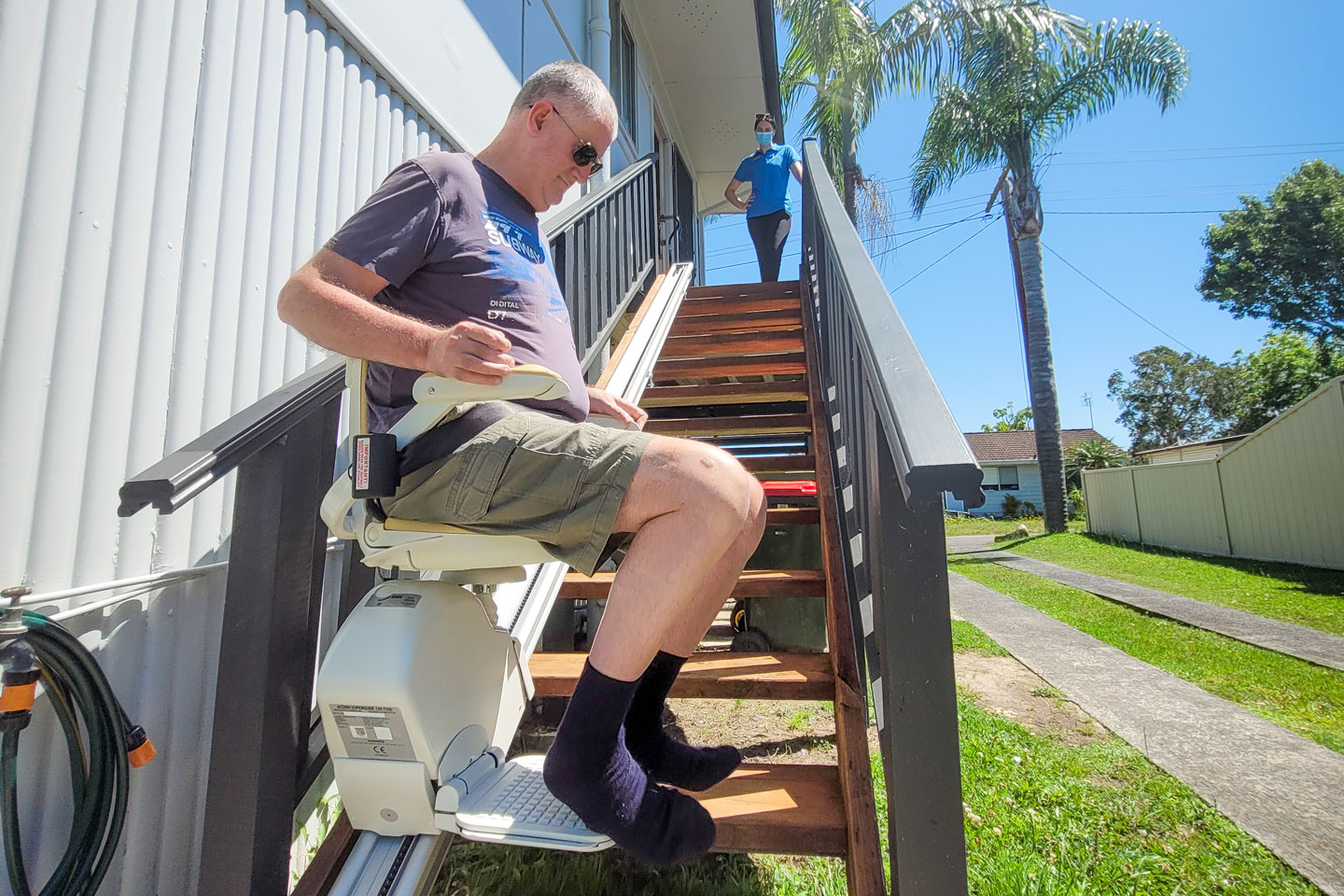 Occupational Therapist supervising the use of a stair lift