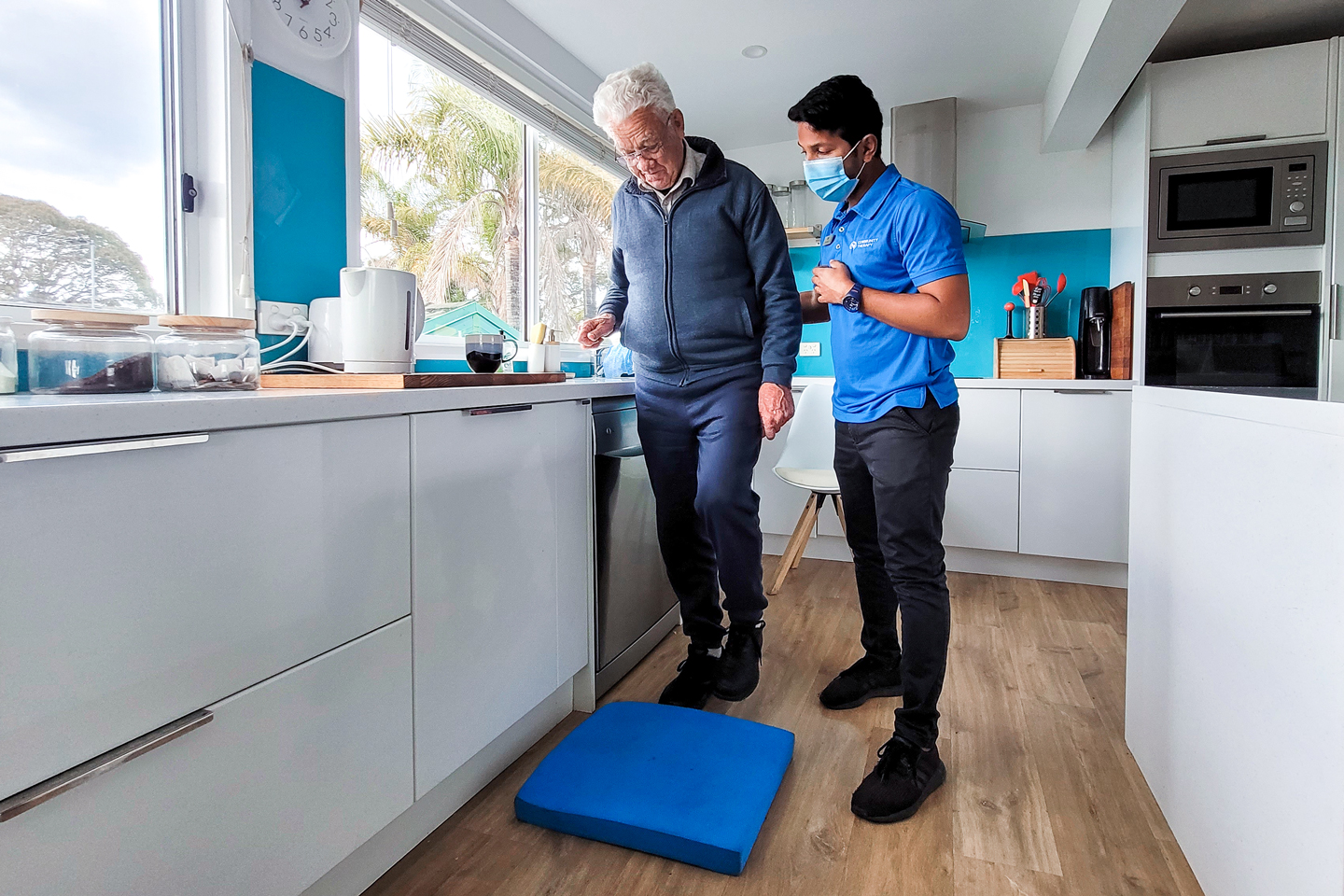 Physiotherapist guiding client through exercises