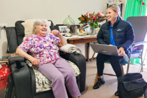 Clinician and client sitting next to each other during an assessment