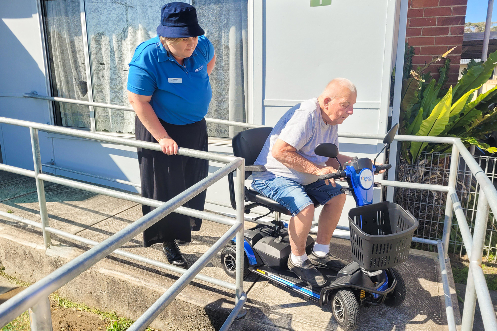 Aged care client navigating a ramp with the assistance of an occupational therapist