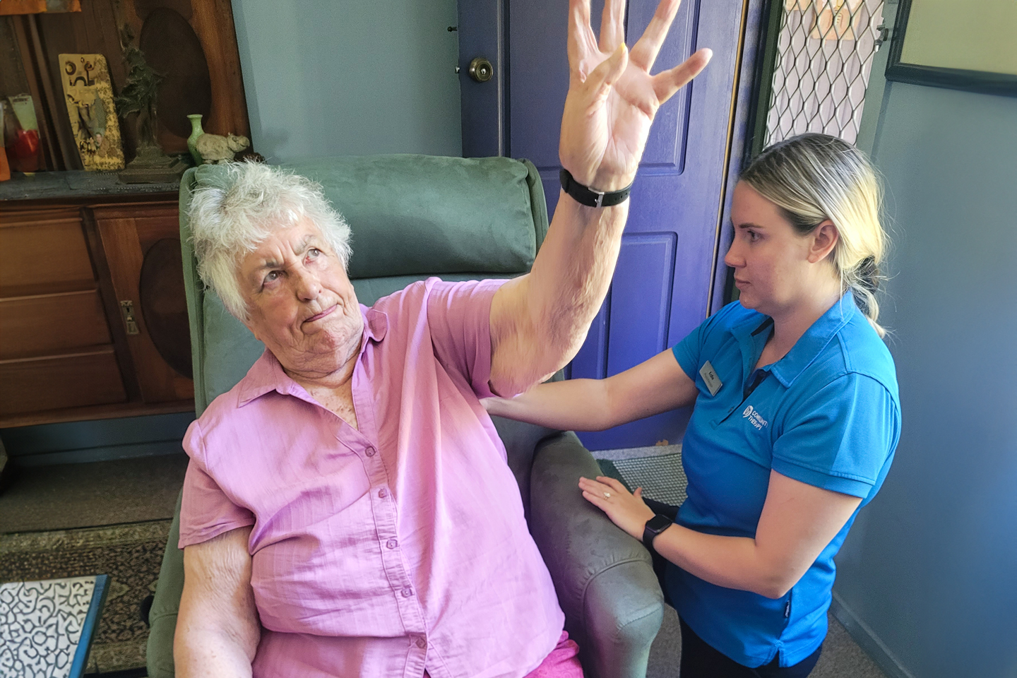 Physiotherapist assessing shoulder range of motion