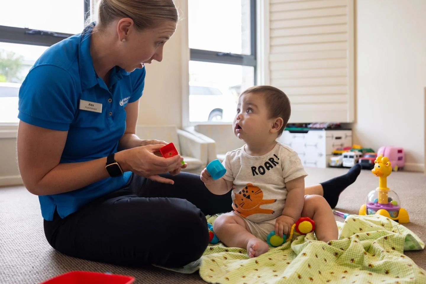 Paediatric Physiotherapist playing with a baby